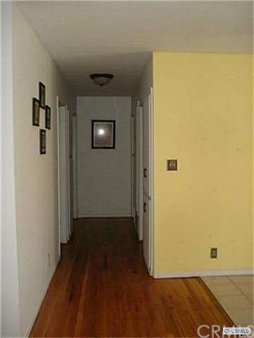 Hardwood floor in hallway leading to bedrooms