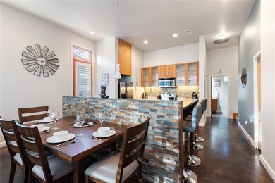 Dining space featuring finished concrete floors a