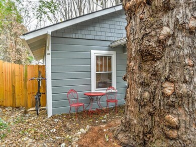 Beautiful Silver Maple and outdoor dining area, with convenient bike storage under the eave.