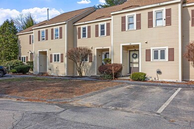 Unit 45, set back between its neighbors, with one of its assigned parking spaces in view.