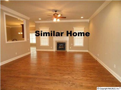 Family room with 10 foot ceiling, wood floor, recessed lighting, ceiling fan, gas logs in fireplace.