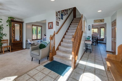 Stairway with tile patterned floors, recessed lighting, and carpet floors