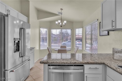 Kitchen with stainless steel appliances, a peninsu