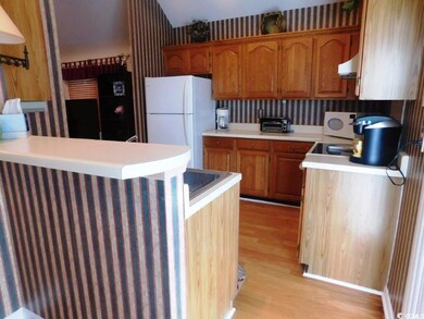 Kitchen featuring white appliances, extractor fan,