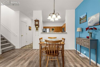 Dining room featuring baseboards, stairs, wood fin