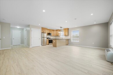 Living Room & Kitchen featuring Open Floor Plan, Luxury Vinyl Plank Floors, and Recessed Lighting