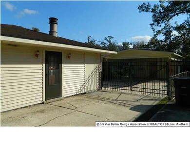 Gated Driveway going to Double Detached Carport