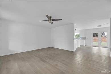 Unfurnished living room with light hardwood / wood-style flooring, french doors, and ceiling fan