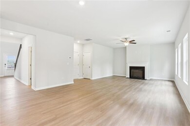 Unfurnished living room with ceiling fan, recessed lighting, light wood-type flooring, and a fireplace with flush hearth