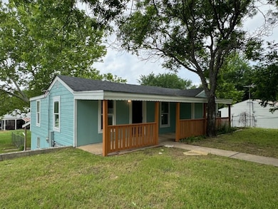 View of front of property featuring a porch and a shingled roof