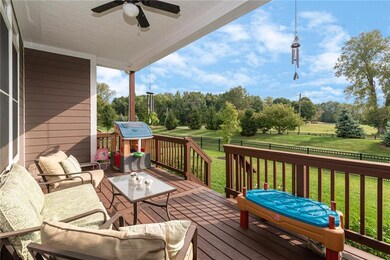 Kick back and relax on the covered back porch overlooking the lush foliage and the horse farm just beyond!