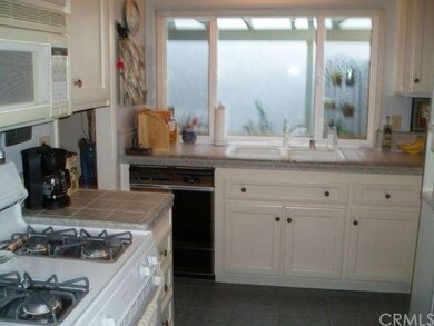 Kitchen showing window to patio