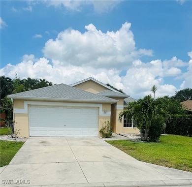 Ranch-style house with driveway, stucco siding, a