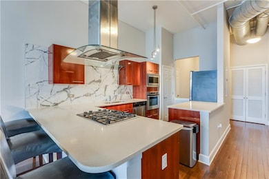 Kitchen with island exhaust hood, dark wood-style 