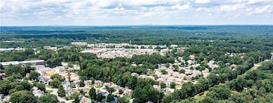 Drone / aerial view featuring a wooded view