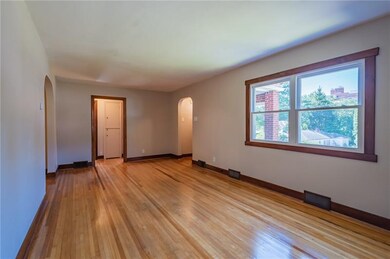 Oh those floors! Original hardwoods have been completely refinished. They are beyond magnificent. This new is from the living room looking towards the entry way on the right and doorway in the middle leads to the 2 bedrooms and bath on the main level