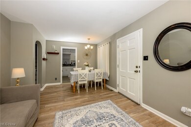 Dining area featuring a chandelier, sink, and light wood-type flooring