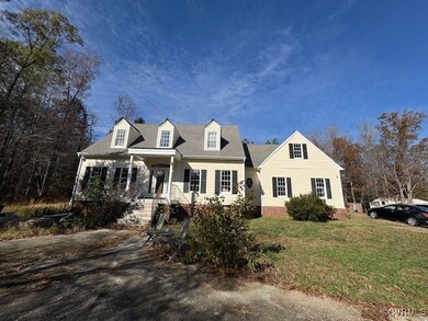 Cape cod house featuring a front lawn