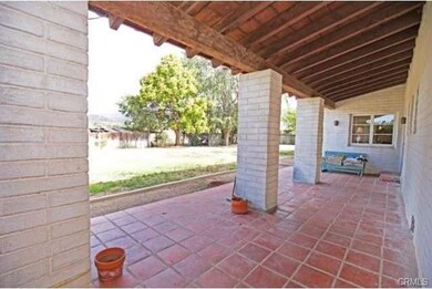 Front porch with open beams and tile pavers!