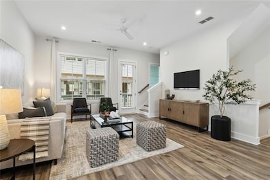 Living room featuring hardwood / wood-style floors and ceiling fan