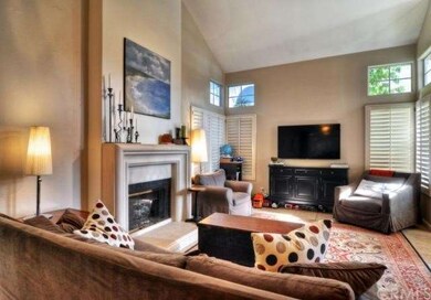 The comfortable living room has multiple windows a
