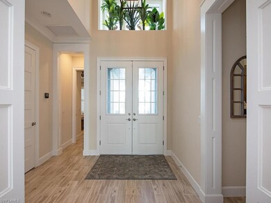 Brightly lit entrance foyer to this grand home.