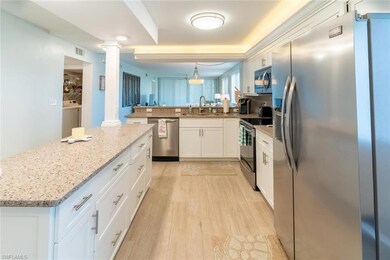 Kitchen with a center island, sink, light hardwood