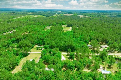 Aerial view featuring a wooded view