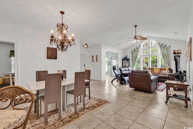 Dining area featuring tile floors and a chandelier
