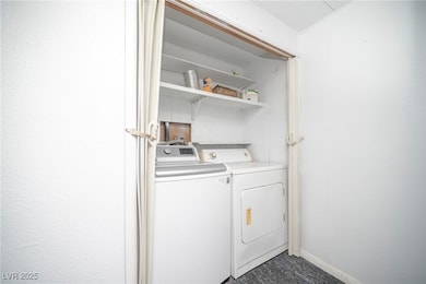 Washroom with washing machine and dryer and basebo
