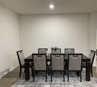 Dining area with wood finished floors and recessed lighting