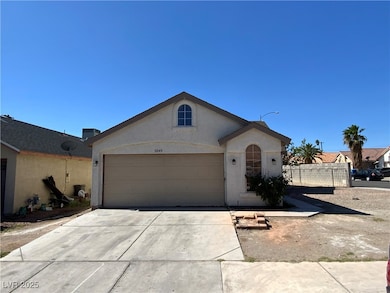View of front facade featuring stucco siding, a ga