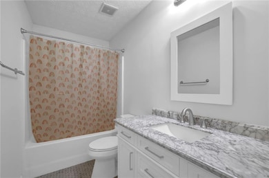 Newly remodeled full bath shared by the secondary bedrooms.