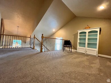 Unfurnished room with vaulted ceiling, carpet floors, recessed lighting, and an upstairs landing