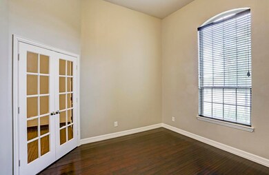 The study is so warm and welcoming with its gleaming hardwood floors and lovely French doors.