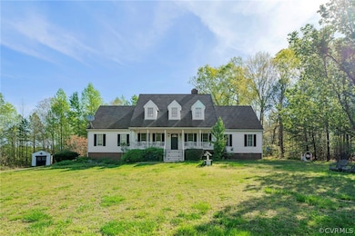 Cape cod-style house with covered porch and a front yard