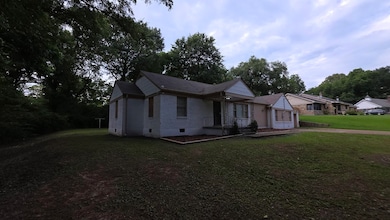 Ranch-style house featuring brick siding, a front lawn, crawl space, and driveway