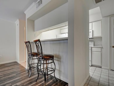 Kitchen featuring white appliances, a kitchen bre