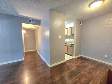 Cozy living area with rich wood flooring, neutral-
