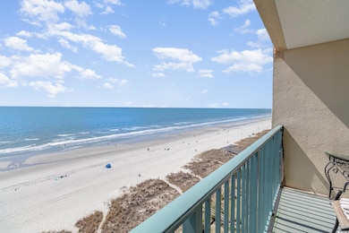 Balcony featuring a beach view and a water view