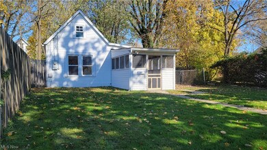 Front of property featuring a lawn and a sunroom