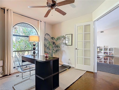 Office featuring concrete flooring and ceiling fan