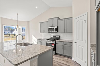 Kitchen featuring sink, an inviting chandelier, ba