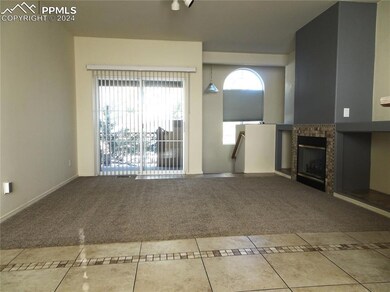 living room with carpet flooring, gas fireplace, a