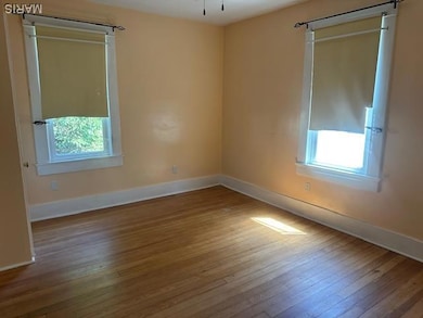Primary bedroom featuring hardwood   flooring.