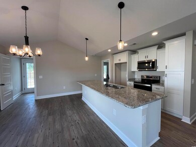 Kitchen featuring white cabinets, sink, stainless 