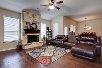 Living room with ceiling fan, hardwood / wood-sty