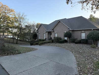 circular driveway and ample parking on side.