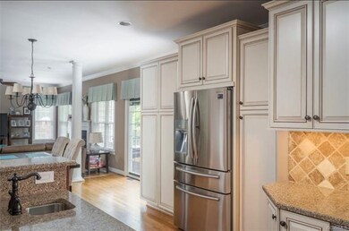 Granite counter tops, high end cabinetry, prep sink in the island, and tumble tile backsplash round out the wonderful details in this kitchen.