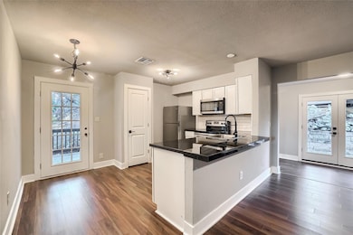 Kitchen featuring baseboards, visible vents, dark